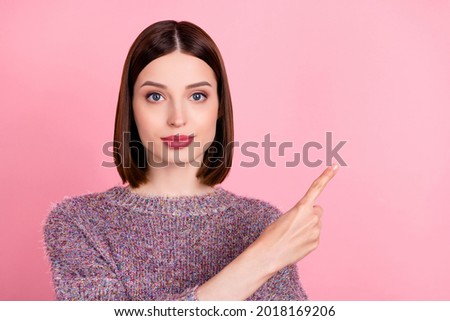 Photo of calm charming lady direct forefinger empty space wear knitted sweater isolated pink color background