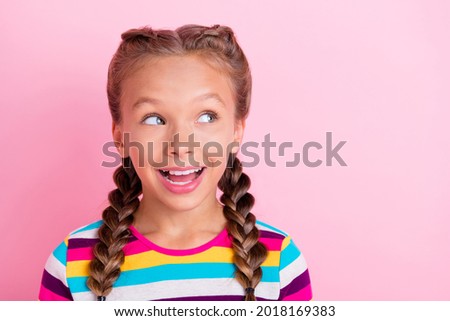 Photo of excited inspired lady look empty space imagine fairy tail wear striped shirt isolated pink color background