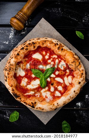 true Italian Pizza. Traditional Pizza Margherita with fresh mozzarella and basil Royalty-Free Stock Photo #2018184977