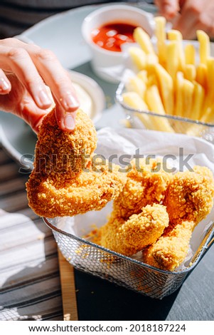 appetizing and hot chicken wings in an airy and crispy batter with different sauces
