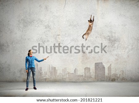 Young woman in casual and cat on leash