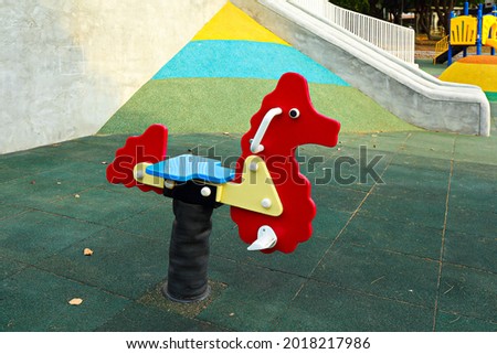 The rocking horse on the green ground at  children's playground
