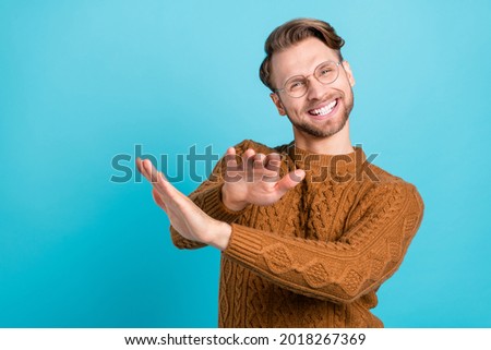 Photo of happy cheerful young man dance good mood weekend wear sweater isolated on blue color background