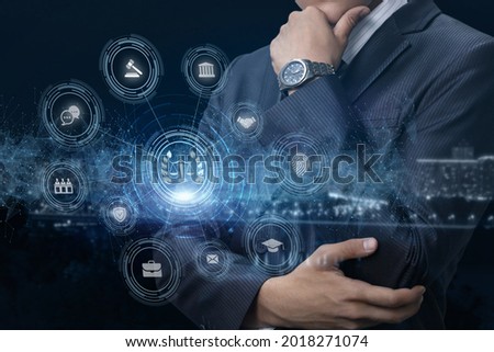 Lawyer thinks and looks at virtual computer screen on blue background.