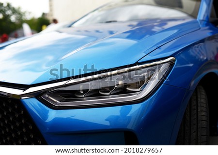 Headlight. LED headlamp of a modern car. Frontal lighting of highway vehicles with daytime running lights. Cars ambient lighting. Bi-Xenon headlamps and LED automotive lighting of a next generation. Royalty-Free Stock Photo #2018279657