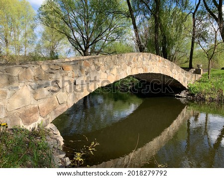 Bridge over a reservoir in the park. Crosswalk across the river. The territory of the castle in Radomyshl, Zhytomyr region, Ukraine