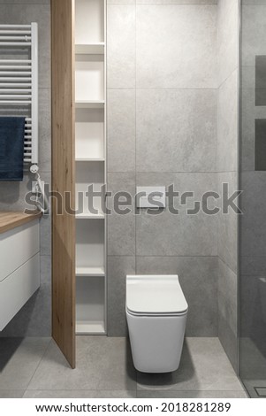 Modern minimalist bathroom interior design with grey stone tiles and wood wall texture
