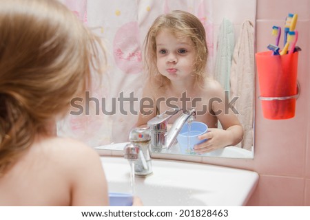 three year old girl to rinse your mouth after brushing your teeth in the bathroom Royalty-Free Stock Photo #201828463