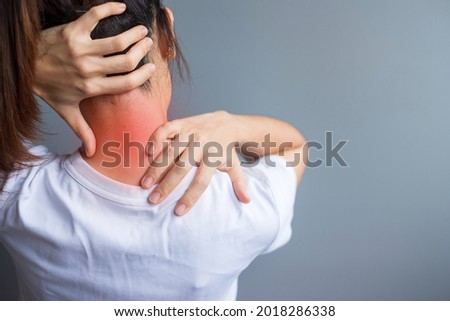 woman with her neck sprain, muscle painful during overwork. Girl having body problem after wake up. Stiff neck, office syndrome and ergonomic concept Royalty-Free Stock Photo #2018286338