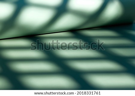 Abstract geometric shadow. Light green monochrome wallpapers. Background for product presentation with shadow and light.