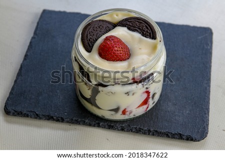 Magnolia dessert with fresh strawberries in glass cup, homemade milky dessert concept