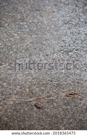 Ice splattering onto cement as a storm begins
