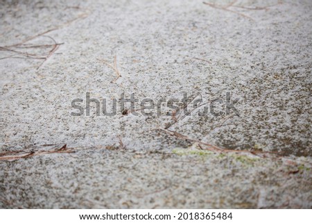 Ice splattering onto cement as a storm begins
