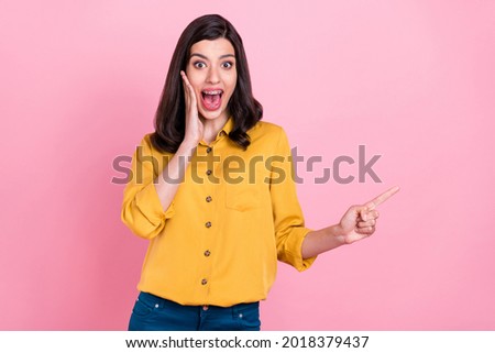 Photo of impressed brunette hairdo millennial lady point empty space wear yellow shirt isolated on pink color background