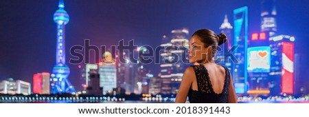 Shanghai woman travel China Luxury lifestyle of the rich chinese millionaires. Asian elegant lady going out in city nightlife looking at skyline vew panoramic landscape.