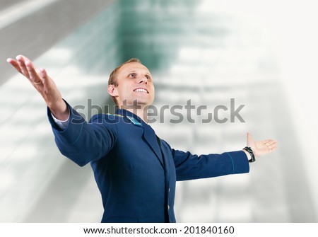 Happy young man aircraft pilot over glass modern building