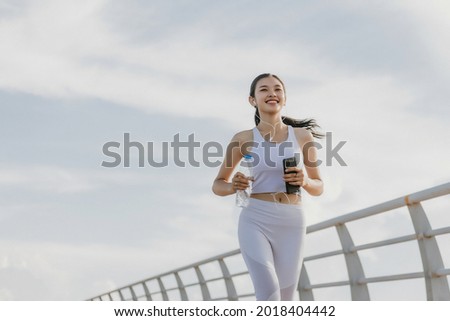 Asian young woman running outdoor, healthy lifestyle, and sport concepts Royalty-Free Stock Photo #2018404442