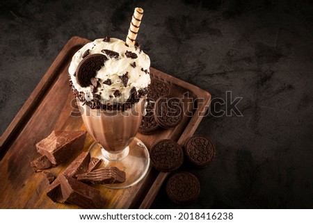 Chocolate milkshake with pieces of chocolate chip cookies. Royalty-Free Stock Photo #2018416238