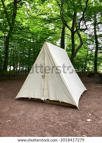 Simple, natural colored canvas tent set up in a campground Royalty-Free Stock Photo #2018417279