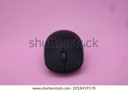 Photo of wireless computer mouse isolated on pink background