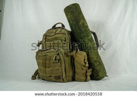 a tactical backpack, with a water bottle pocket and a personalized sleeping pad