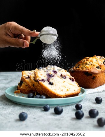 Blueberry Loaf - dusting sugar on slices of loaf