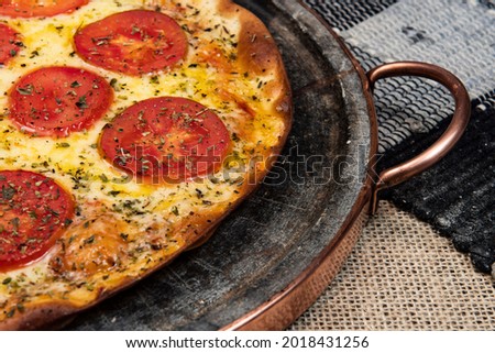 Neapolitan Brazilian pizza with mozzarella cheese and tomato slices with oregano, top view