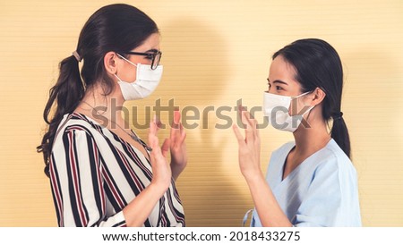Happy friends take off face mask and hug each other closely together showing concept of the end of quarantine and winning over COVID-19 .