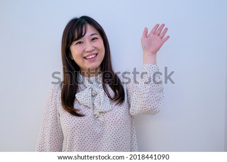 Woman waving with a smile