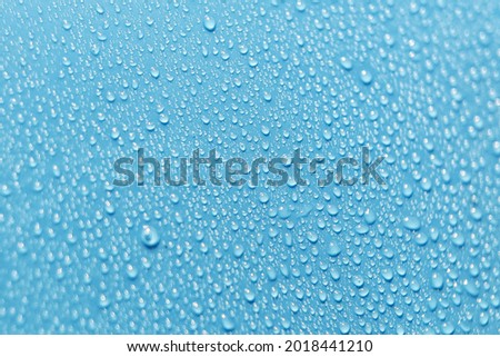 Abstract Blue background of waterdrops, droplets. Selective focus.