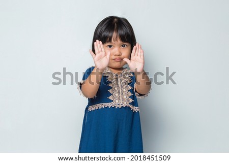 Asian little girl making stop gesture with her hand
