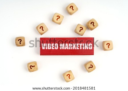 Question concept. On the table are cubes with questions and a red plaque with the inscription - Video Marketing