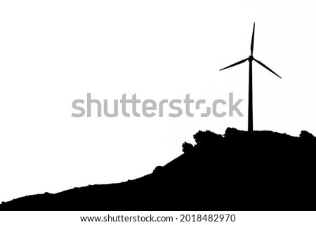 Windmill turbine on the top of the mountain in Southern Spain. Monochrome picture.