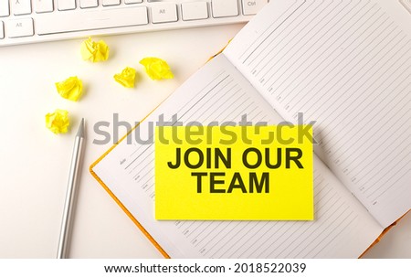 JOIN OUR TEAM text on sticker on the diary with keyboard and pencil