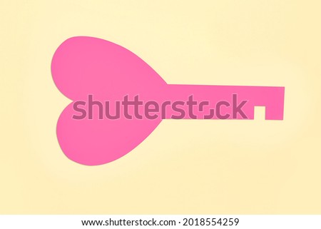 Paper key with heart on color background