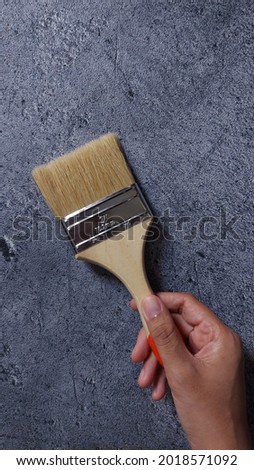wall paint brush.  Isolated background in gray