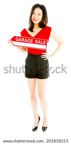 Saleswoman holding a Garage sale sign and smiling