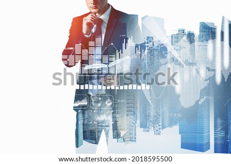 Businessman in suit is looking into his notes on notebook. White glowing charts and globe icon. Singapore city view, double exposure