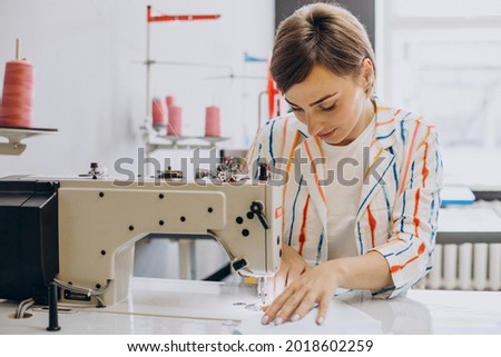 Female tailor working on sewing machine