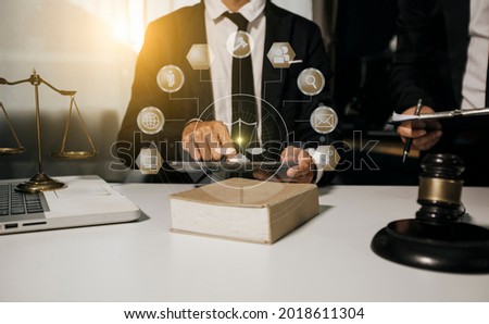 Law and Legal services concept, Lawyer businessman working with digital tablet at the table office and law innovation technology interface icons, Blurred background.