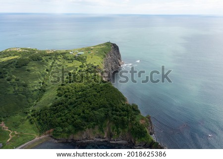 Aerial drone photo of Mayachny Cape on Kamchatka Peninsula on picturesque Avacha bay coast covered by green grass in the Pacific Ocean