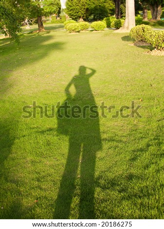Shadow of a people on the green grass.