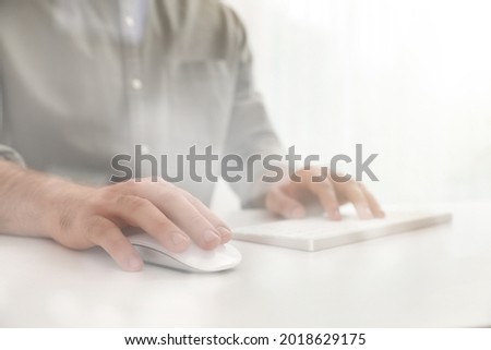 Man using computer mouse at desk, closeup