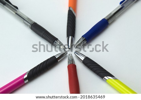 foreground of color pens on a white background