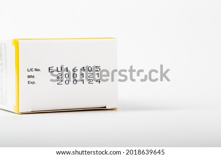 Instruction of lot number, manufacturing date, and expiry date label of a product on the bottom lid of the package with isolated white background and copy space. Royalty-Free Stock Photo #2018639645
