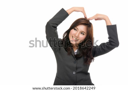 Happy young Asian woman showing heart sign to confess love or love sign ,relationship concept of human emotions and facial expression,portrait of beautiful Asian woman, isolated on white background