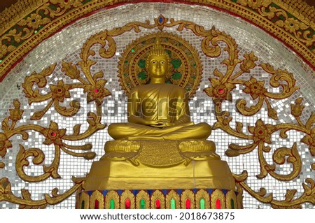 Buddha statue is art Thailand. Artistic low relief in front of the temple.