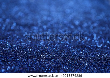 Shiny blue glitter as background. Bokeh effect Royalty-Free Stock Photo #2018674286