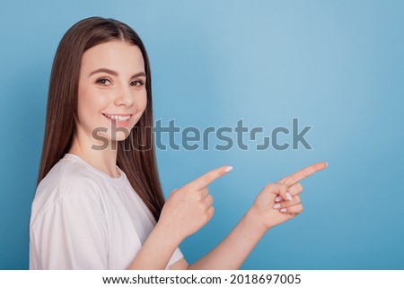 Portrait of reliable promoter lady look camera direct fingers empty space on blue background