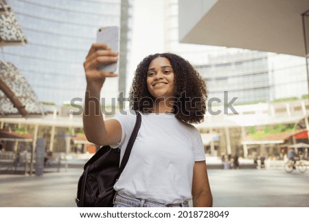 A tourist is taking a selfie in the city